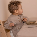 Luna_bib_coated-Bib-NU494-Cream_carnival_train_1024x_d464e238-07a4-4cd1-900e-f29cac30277b_1080x.webp